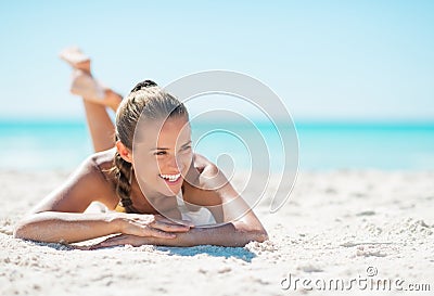Portrait of smiling young woman laying on beach Stock Photo