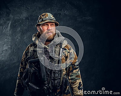 Portrait of a special forces soldier in the military camouflaged uniform, looking sideways. Stock Photo