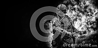 Portrait of a special forces soldier waving a sledgehammer to smash an obstacle. The concept of military units. Computer games Stock Photo