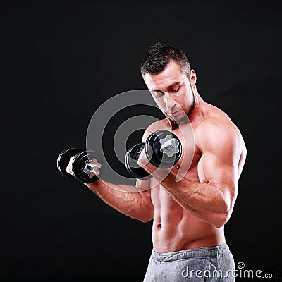 Portrait of a sportsman lifting dumbbells Stock Photo