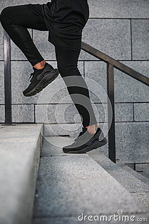 Portrait of sportsman running up stairs Stock Photo