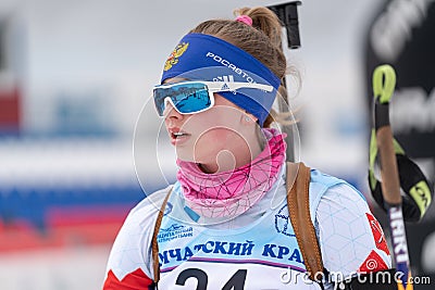 Portrait sportswoman biathlete Vlada Shishkina (St. Petersburg) at finish after skiing, rifle shooting. Junior Editorial Stock Photo