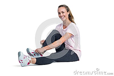 Portrait of sporty woman smiling while tying shoelace Stock Photo