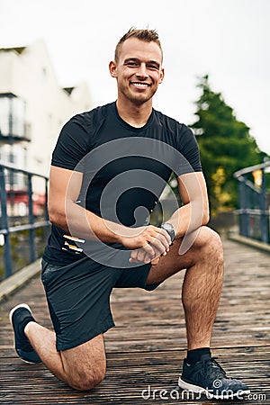 Gotta make sure my shoes are snug. Portrait of a sporty young man tying his shoelaces while exercising outdoors. Stock Photo