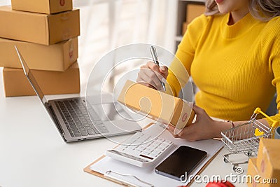 Portrait of Starting small businesses SME owners female entrepreneurs working on receipt box and check online orders to prepare to Stock Photo