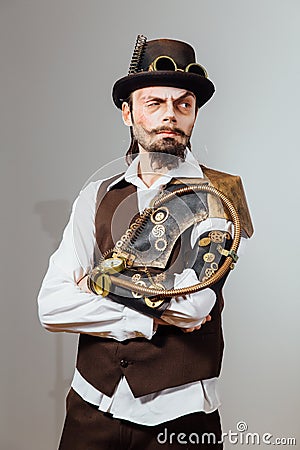 Portrait of steampunk vintage man with various mechanical devices on body. Stock Photo