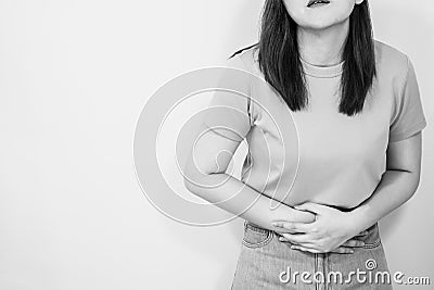 Portrait stomach ache sick and pain feeling of woman 30s to 40s with monochrome and red spot on hurt point Stock Photo