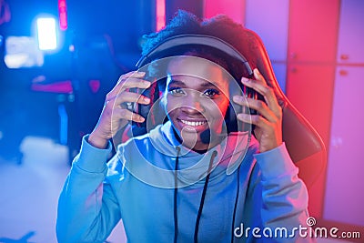 Portrait Streamer African young woman professional gamer playing online games computer, neon color Stock Photo