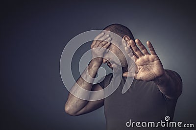 Portrait of a stressed man with his eyes closed and his hand on his forehead Stock Photo