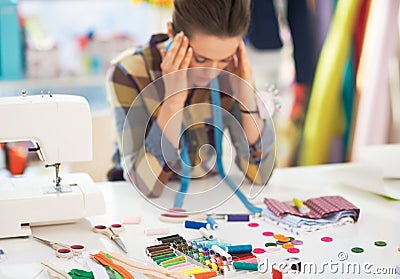 Portrait of stressed tailor woman at work Stock Photo