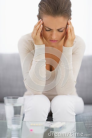 Portrait of stressed young housewife in living room Stock Photo