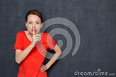 Portrait of strict indignant girl showing silence sign Stock Photo