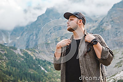 portrait of strong hiker man in front of lake in mountains Stock Photo