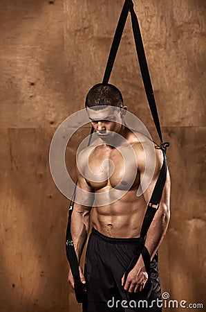 Bodybuilder with suspension rope Stock Photo