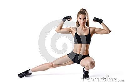 Portrait of strong muscular woman flexing her biceps and stretching leg. Cutout fitness girl. Stock Photo