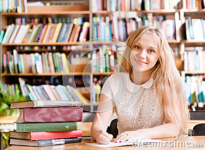 Portrait of a student girl studying at library Stock Photo