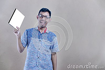 Portrait of student using glasses standing with book of photography Stock Photo