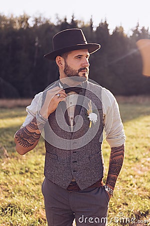 Portrait of stylish beard, male with tattoos on his arms. Wedding portrait Stock Photo