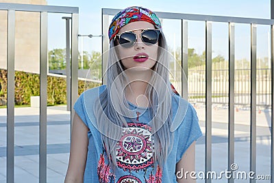 Portrait of stylish glamorous young woman wearing big black sunglasses and hippie style clothes Stock Photo