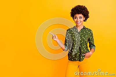 Portrait of stylish positive afro american girl promoter point index finger copy space demonstrate adverts suggest Stock Photo