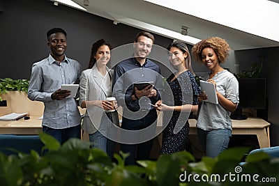 Portrait of successful diverse employees team holding electronic devices Stock Photo