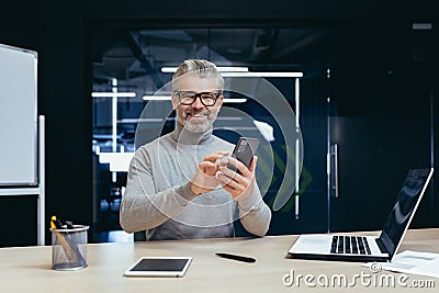 Portrait of successful mature investor inside office with work, gray-haired businessman smiling and looking at camera Stock Photo