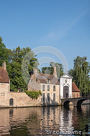 Portrait, Sunlit Beguinage wall and entrance, Bruges, Belgium Stock Photo