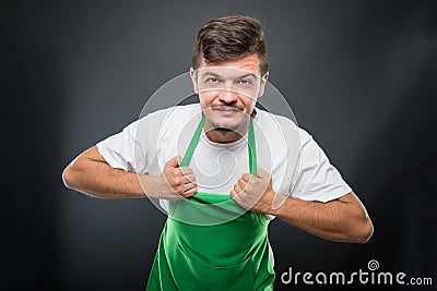 Portrait supermarket employer holding his apron Stock Photo