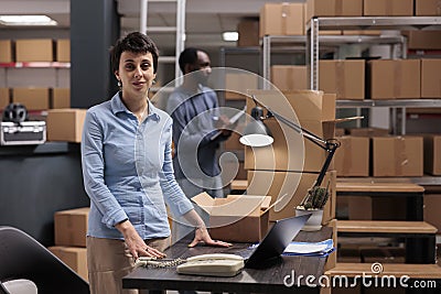 Portrait of supervisor working in storehouse delivery department checking shipping details Stock Photo