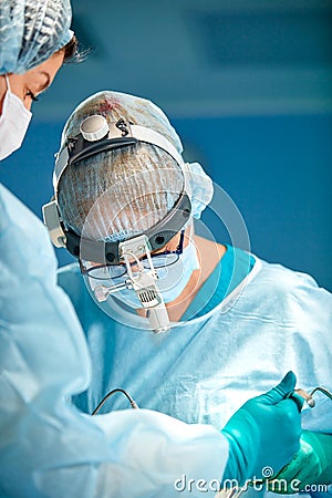 Portrait of a surgeon close-up. Surgeons operate on a patient. Tense, serious faces. Real operation. Tensioned Stock Photo