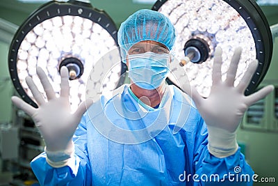 Portrait of surgeon preparing for operation in operation room Stock Photo