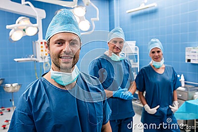 Portrait of surgeons smiling in operation room Stock Photo