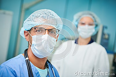 Portrait of surgeons team in hospital. Colored male and caucasian female doctors Stock Photo