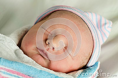Portrait of swaddled infant moments after birth Stock Photo