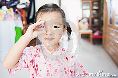 Sweet Asian little child smile and holding hair clip, hair dressing concept Stock Photo