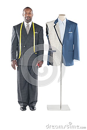 Portrait of tailor in formal wear standing besides a dummy Stock Photo