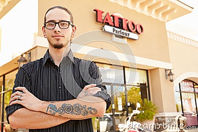 Portrait Of Tattoo Artist Standing Outside Parlor Stock Photo