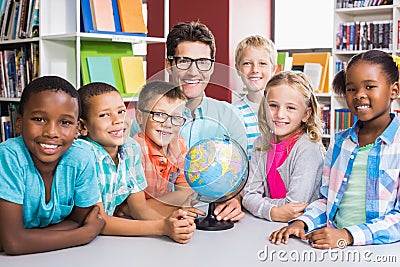 Portrait of teacher and kids with globle Stock Photo