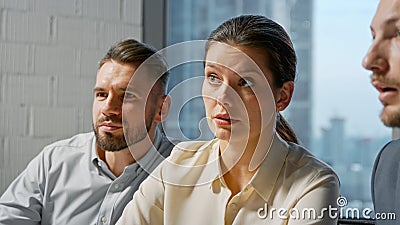 Portrait of a team of professionals communicating in a meeting while sitting at desk Stock Photo
