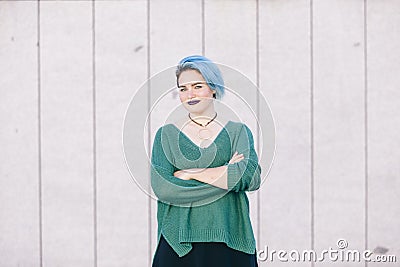 Portrait of a teen androgynous woman with blue dyed hair isolate Stock Photo