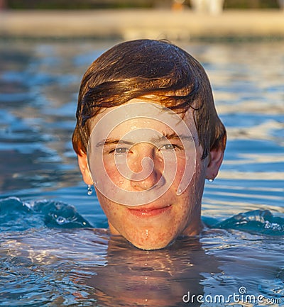 Portrait of a Teen Boy swimming in the pool Stock Photo