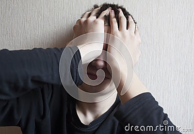 Portrait of a teenage boy in a state of shock and depression Stock Photo