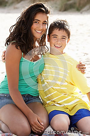 Portrait teenage brother and sister on beach Stock Photo