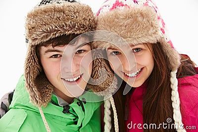 Portrait Of Teenage Couple In Snow Stock Photo