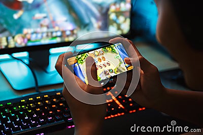 Portrait of teenage gamer boy playing video games on smartphone Stock Photo