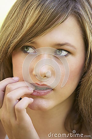 Portrait Of Teenage Girl Biting Nails Stock Photo