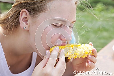 Portrait of a teenage girl eating sweet boiled corn Stock Photo