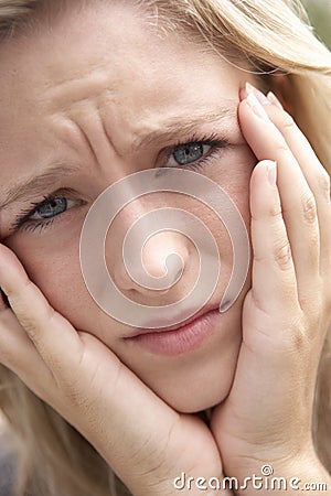 Portrait Of Teenage Girl Frowning Stock Photo