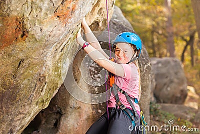 Young mountaineer training rock climbing outdoors Stock Photo