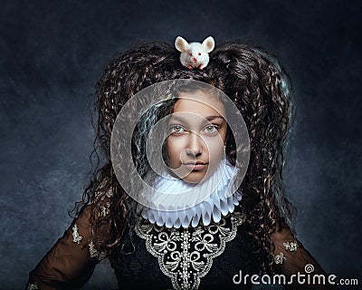 Portrait of a teenage girl with a white mouse on her dark curly hair Stock Photo